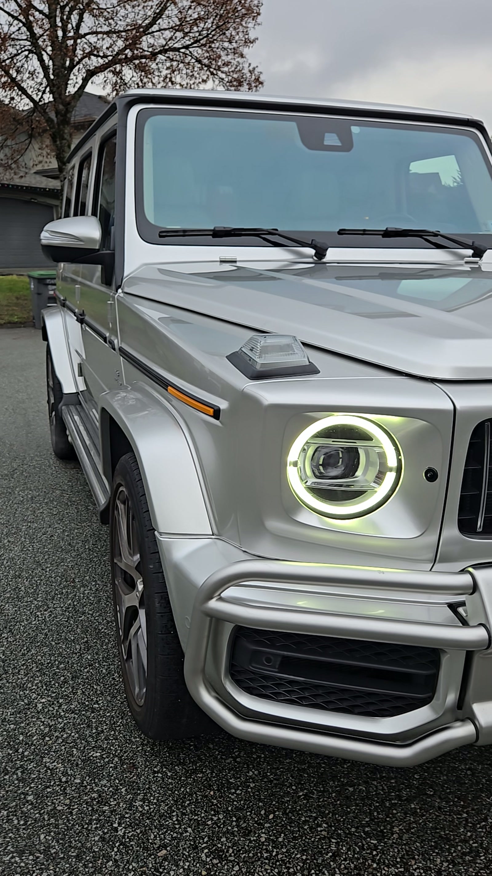 Satin grey vinyl wrap on a Mercedes-AMG G-Class, front-corner detail
